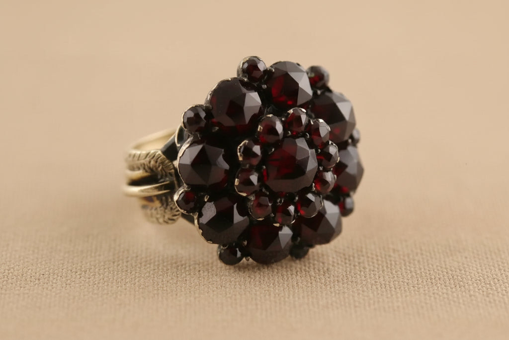 Ring with garnet stones on a white background