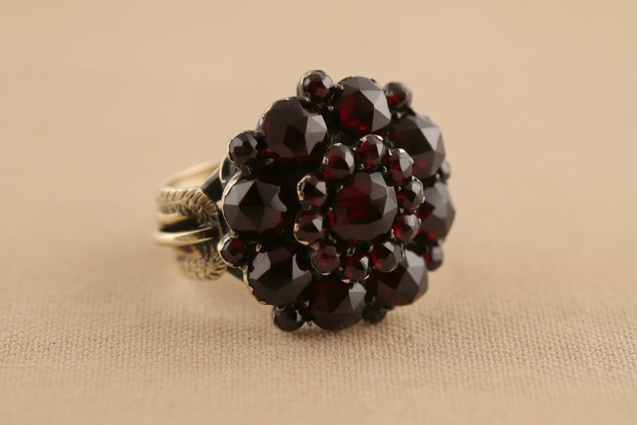 Ring with garnet stones on a white background