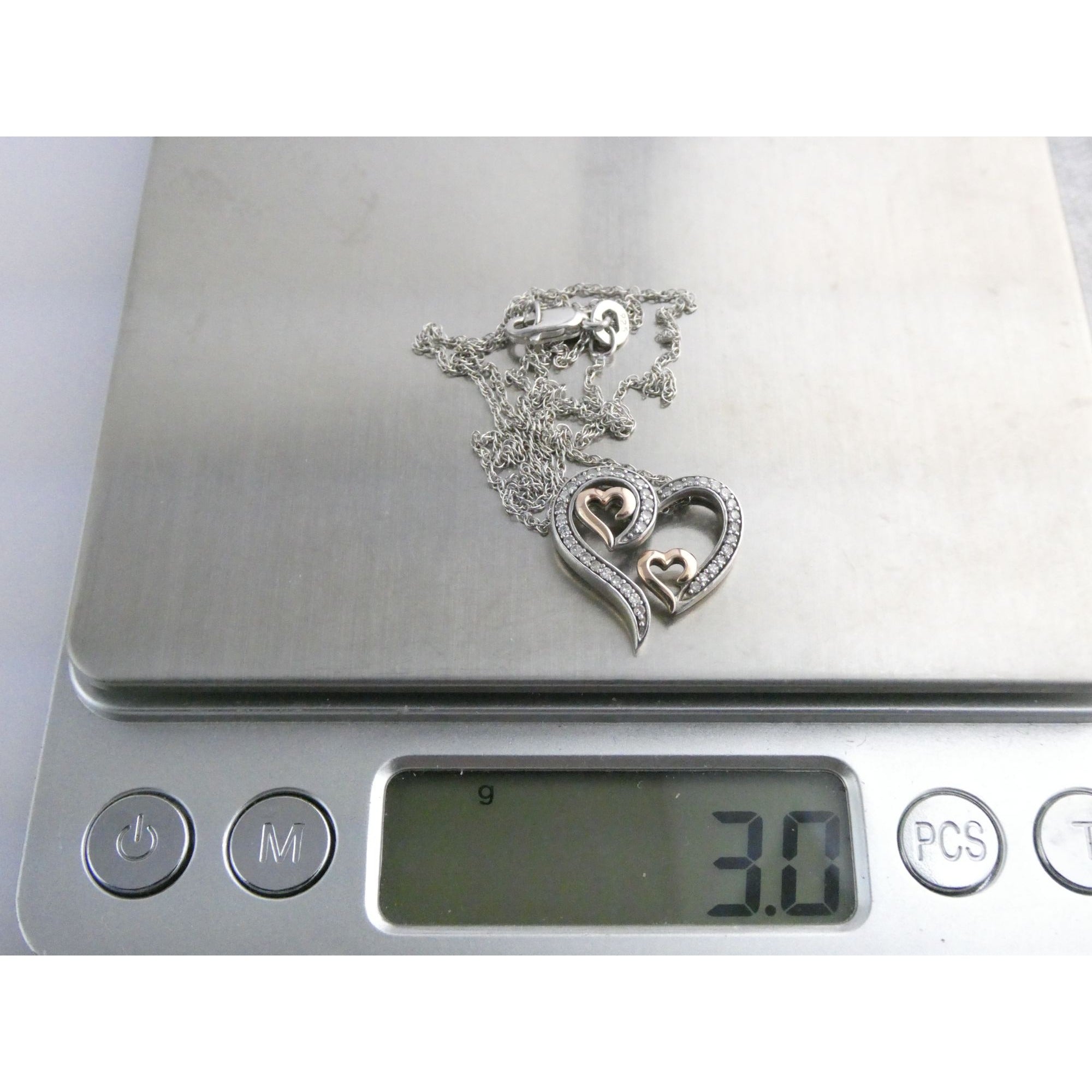 CO Sterling Silver and 10k Gold Natural Diamond Three Hearts Pendant Necklace