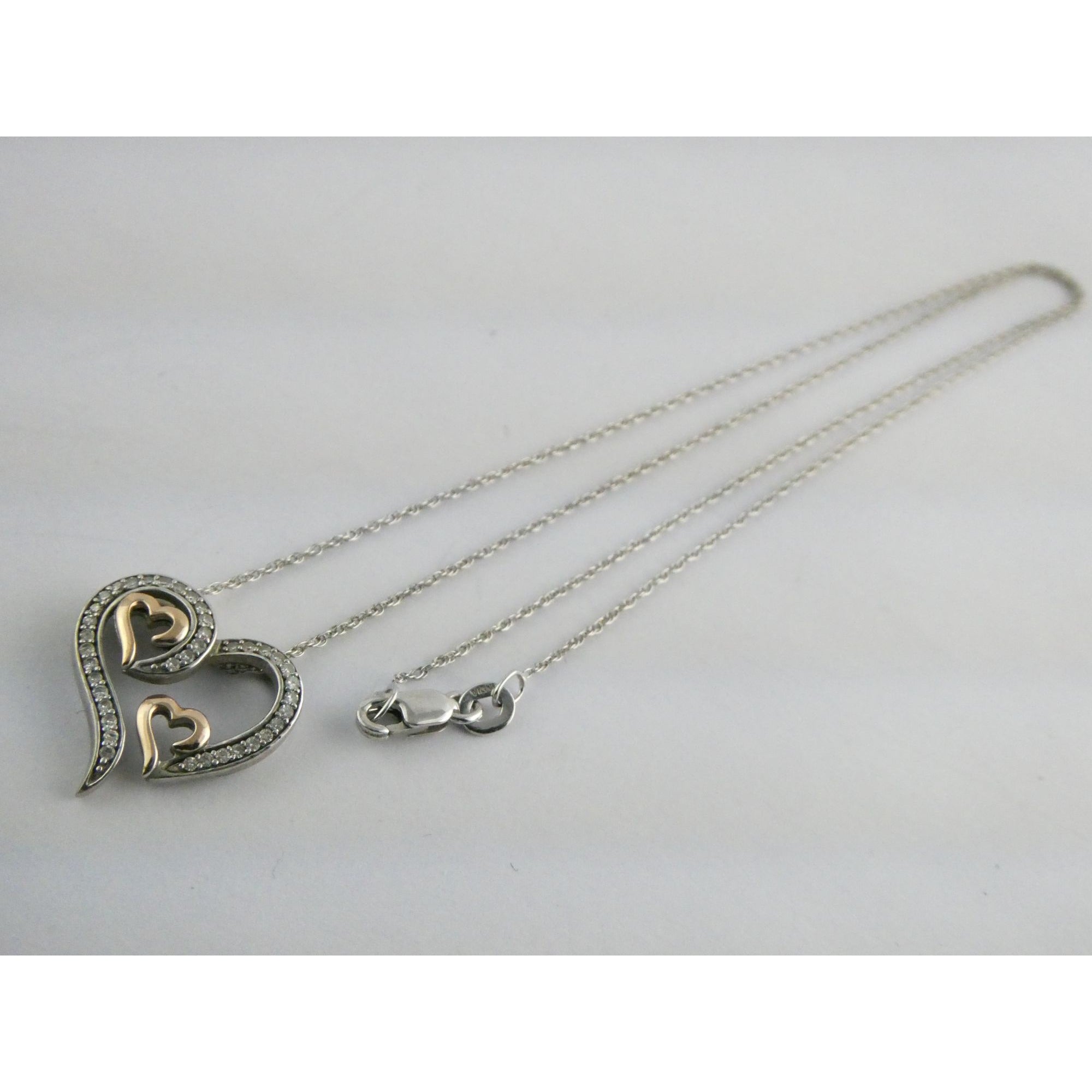 CO Sterling Silver and 10k Gold Natural Diamond Three Hearts Pendant Necklace