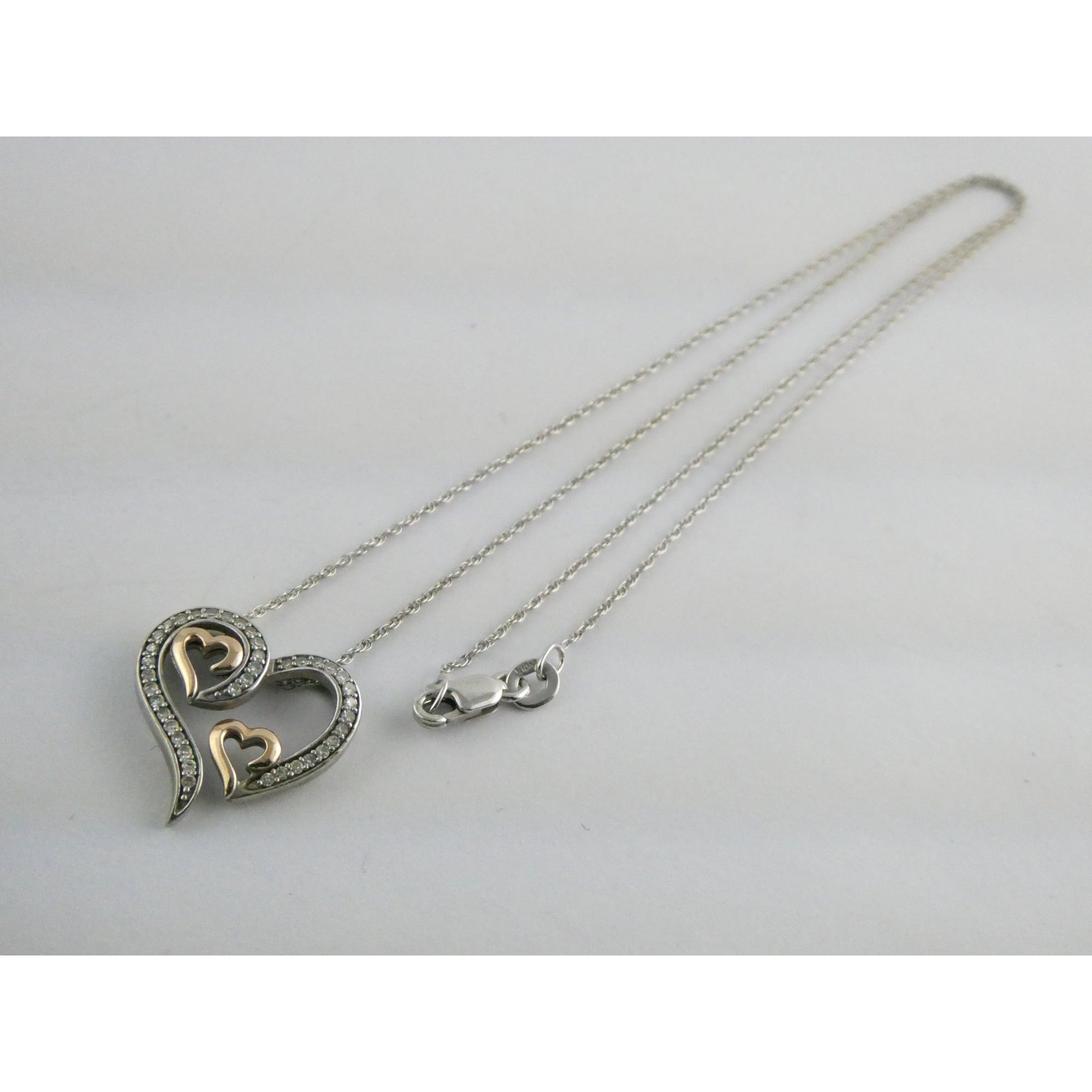 CO Sterling Silver and 10k Gold Natural Diamond Three Hearts Pendant Necklace