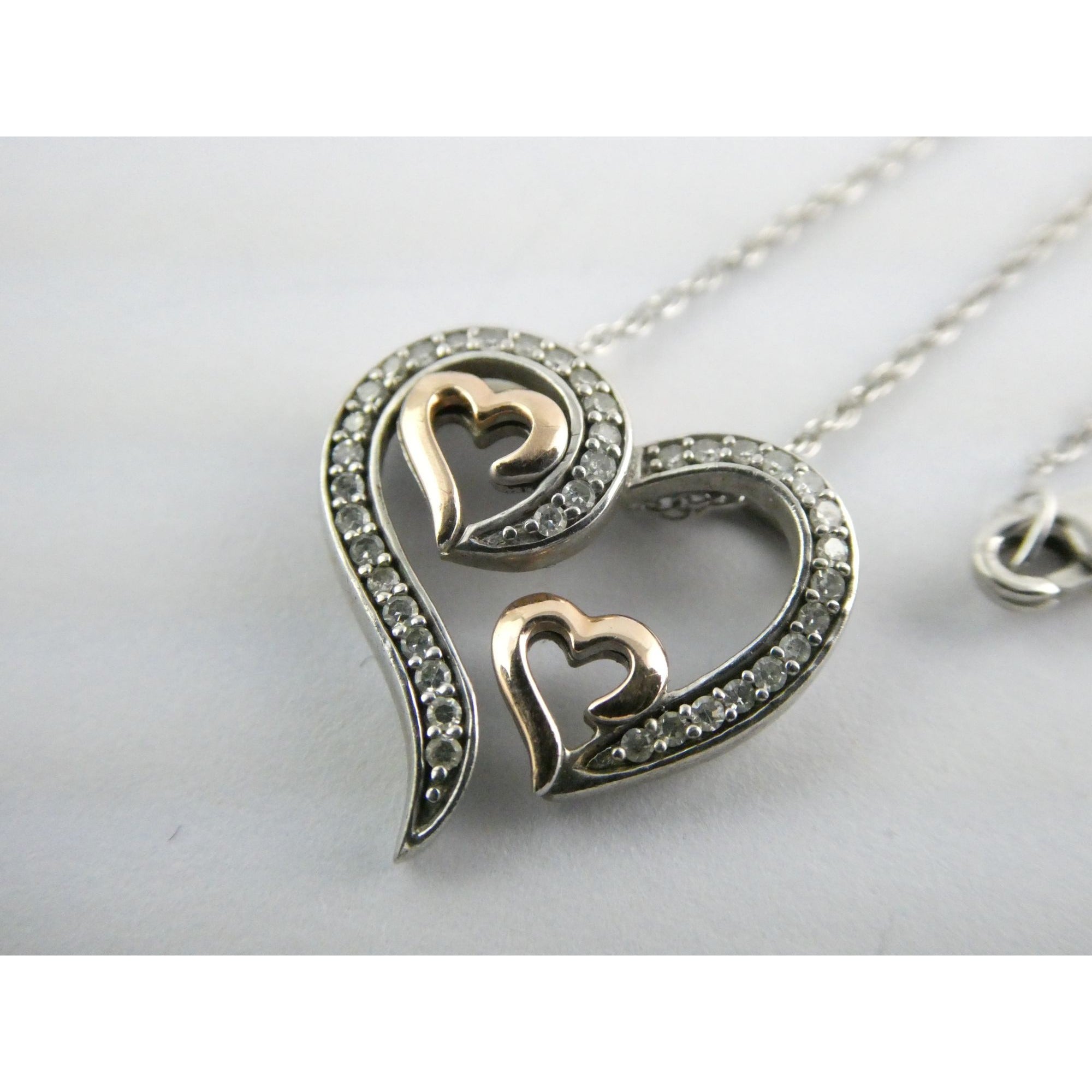 CO Sterling Silver and 10k Gold Natural Diamond Three Hearts Pendant Necklace