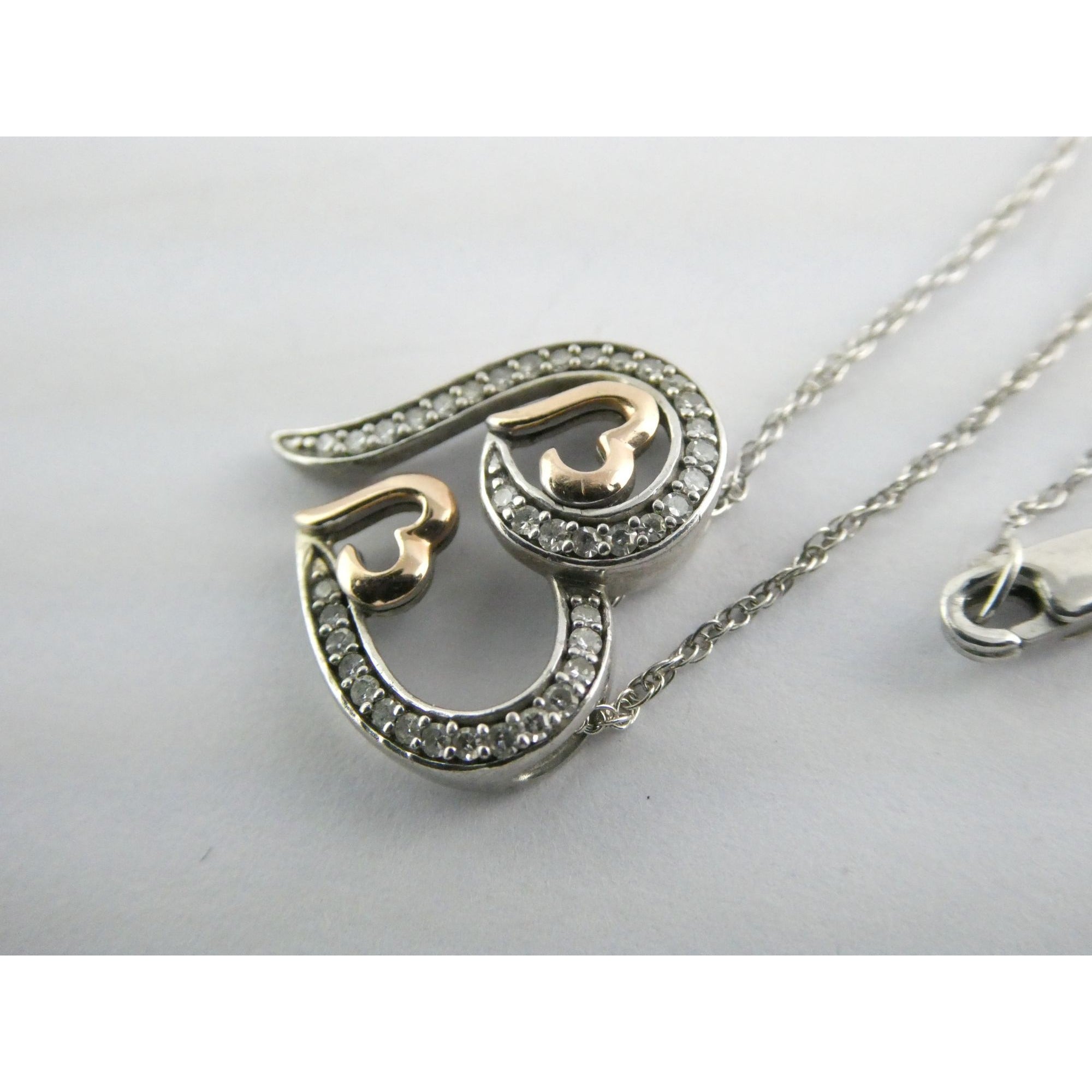 CO Sterling Silver and 10k Gold Natural Diamond Three Hearts Pendant Necklace